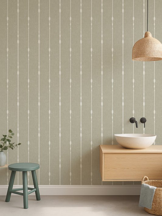 Light green vertical stripe wallpaper behind a floating wood vanity with a bowl sink and woven pendant light