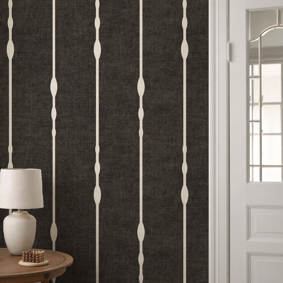 Vertical striped wallpaper in Black and White in living room with white panelling and table lamp