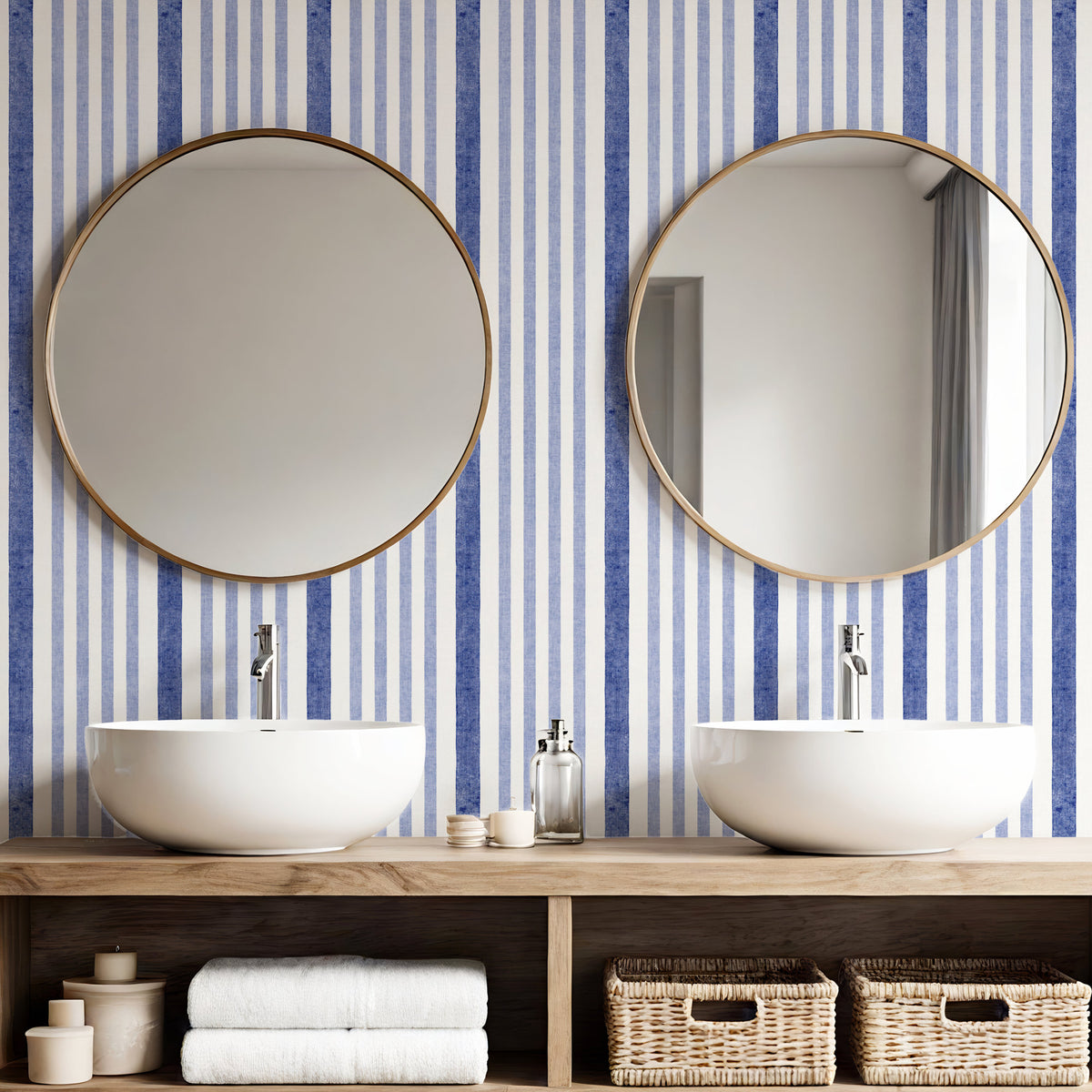Painted stripe wallpaper in blue and white in bathroom with round mirrors and twin basins