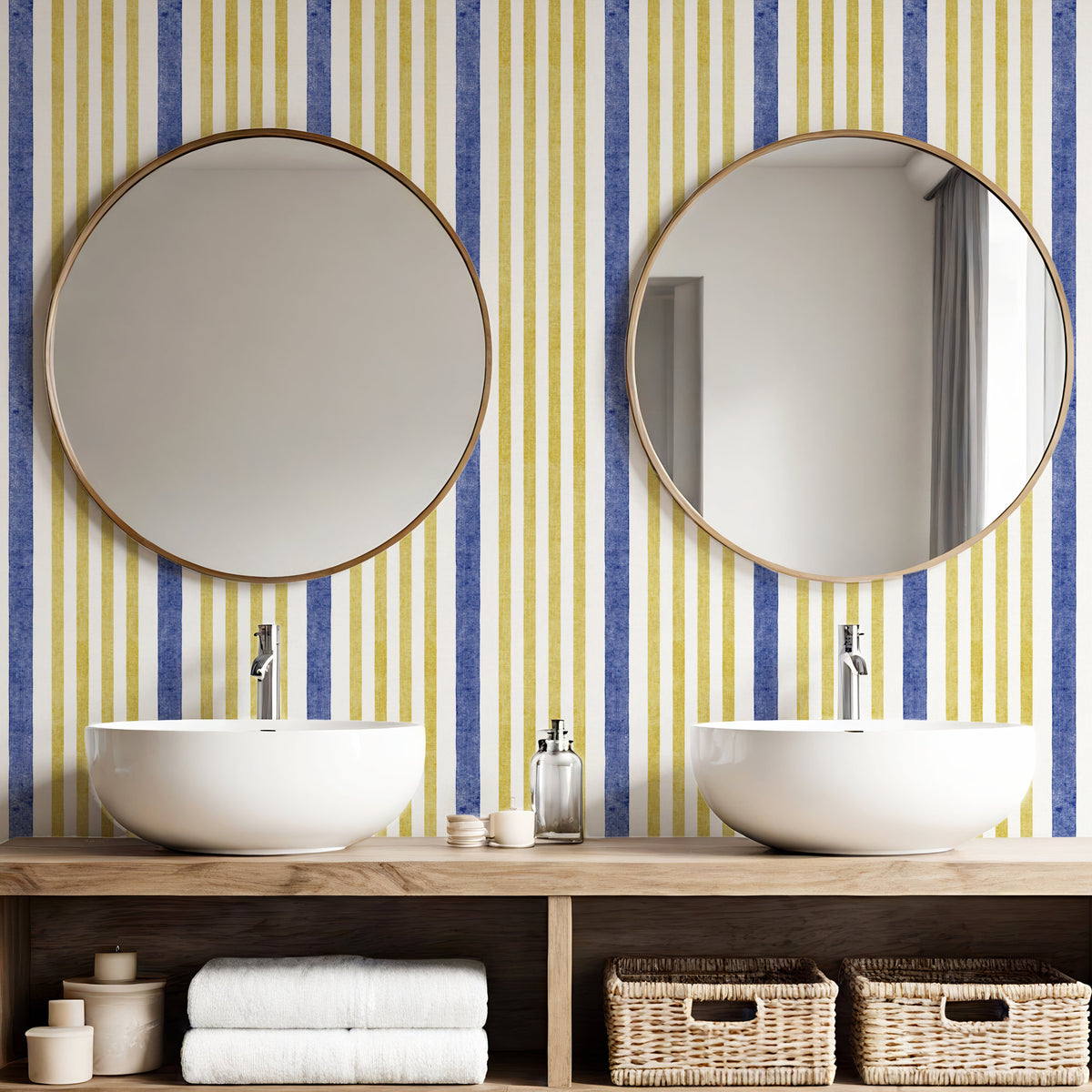 Painted stripe wallpaper in blue and yellow in bathroom with round mirrors and twin basins