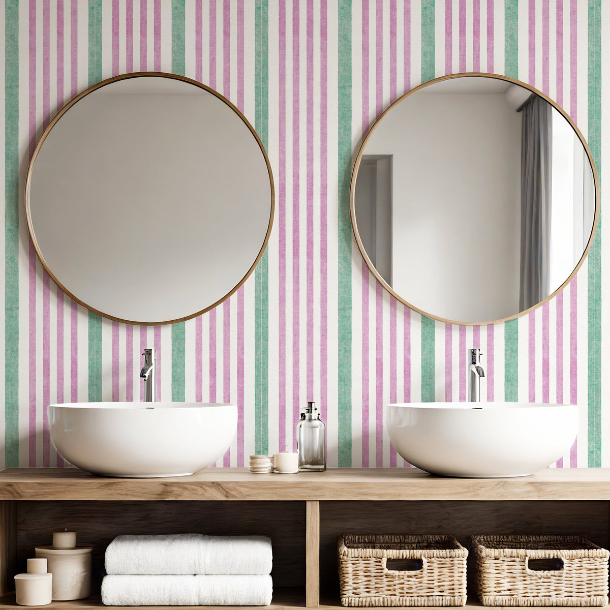 Painted stripe wallpaper in pink and green in bathroom with round mirrors and twin basins
