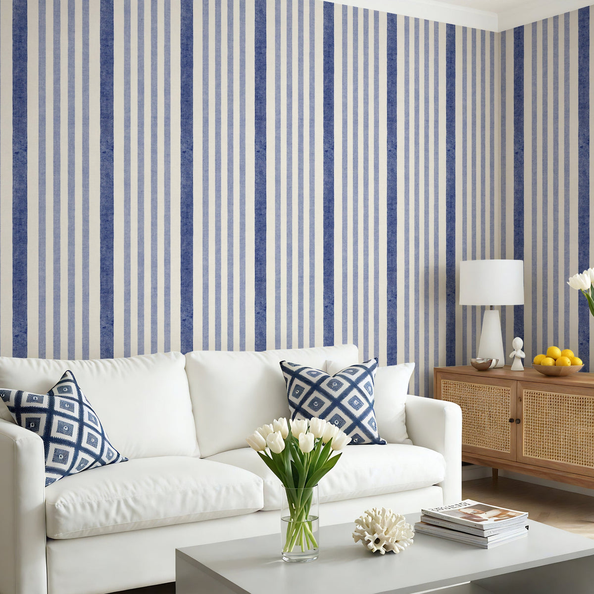 Painted stripe wallpaper in blue and white in living room with white sofa and coastal decor