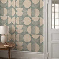 Teal mid-century modern circle wallpaper in hallway with white panelling and side table