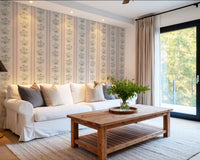 Pink and yellow floral stripe wallpaper in living room with white sofa and wood coffee table