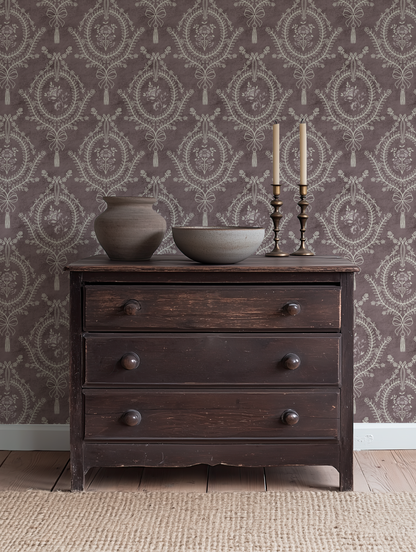 Muted Burgundy Damask Wallpaper – neoclassical floral medallion design styled in a traditional living room with dark wood furniture.