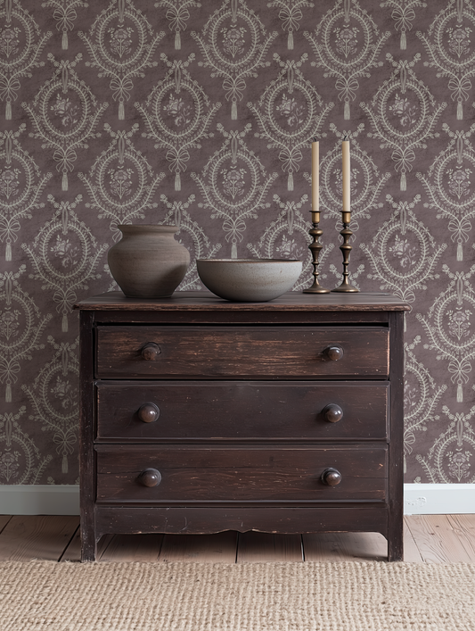 Muted Burgundy Damask Wallpaper – neoclassical floral medallion design styled in a traditional living room with dark wood furniture.