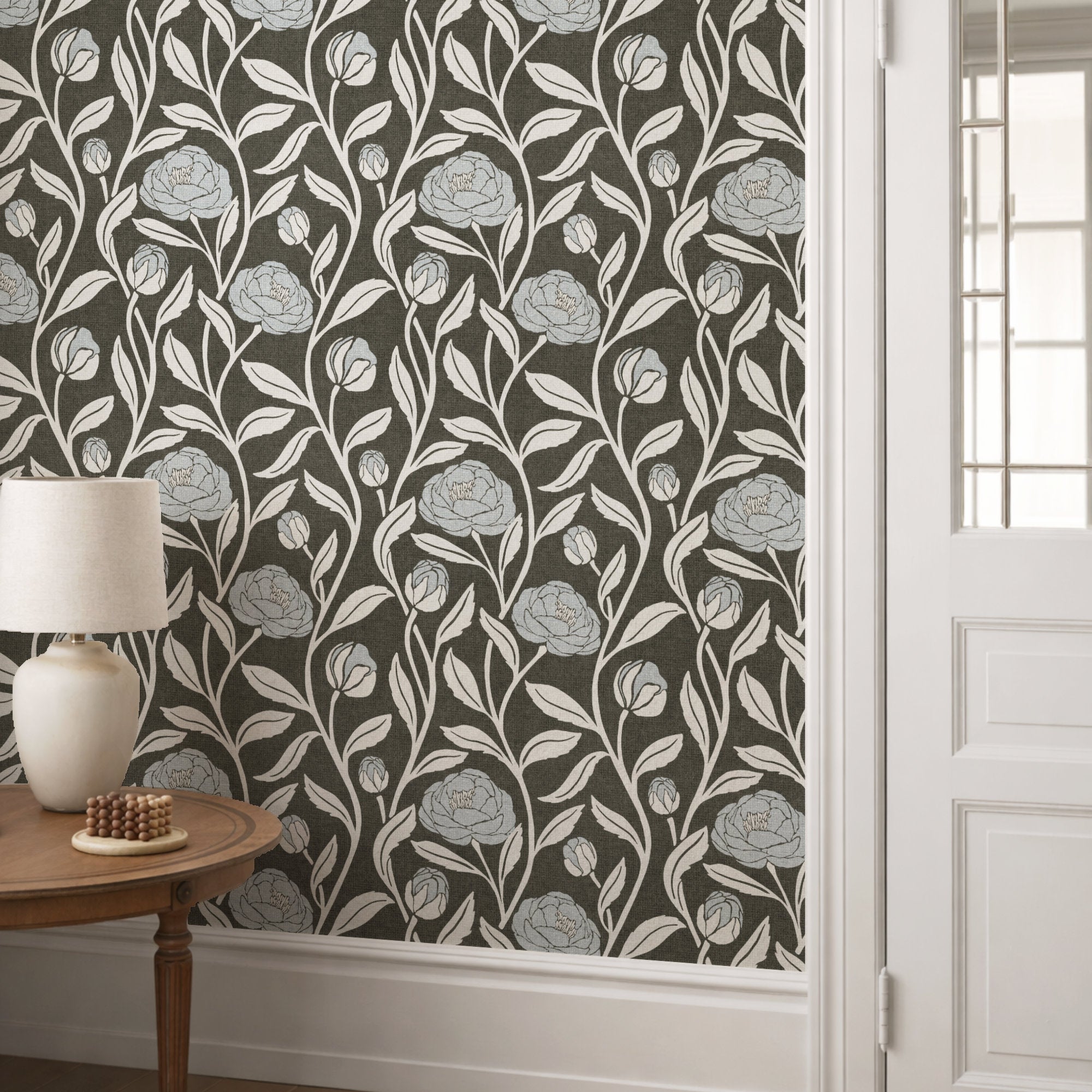 Charcoal grey peony flower wallpaper in a hallway, pale peonies on a smoky charcoal ground