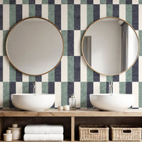 Wide block stripe wallpaper in slate blue and white in bathroom with round mirrors