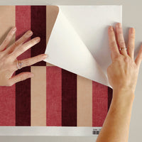 Peel and stick block stripe wallpaper being peeled to show removable backing