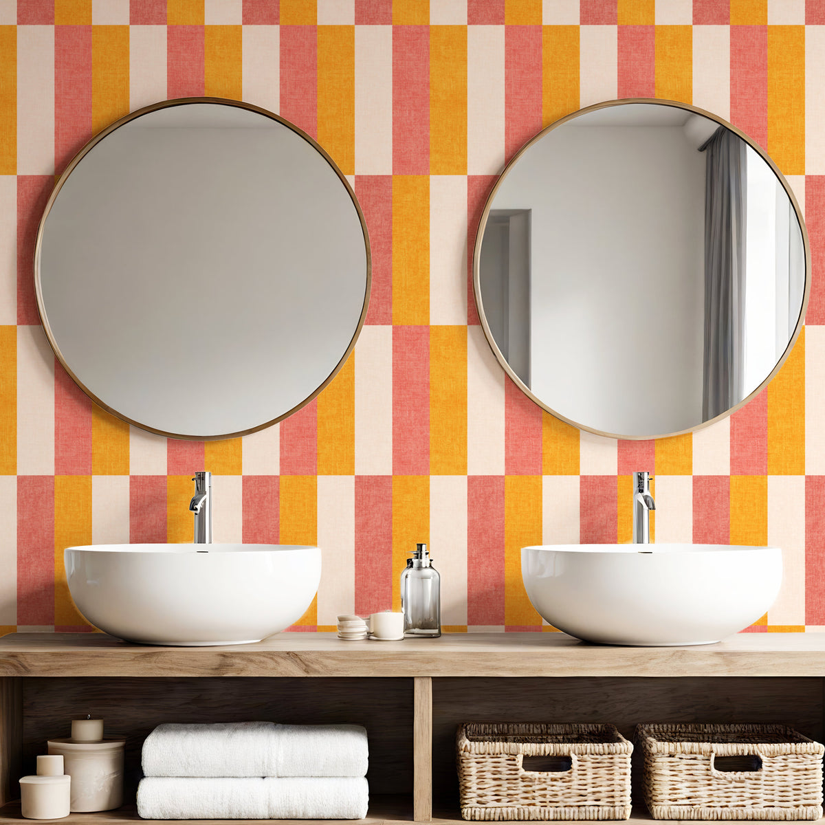 Retro block stripe wallpaper in coral pink and amber orange in bathroom with round mirrors