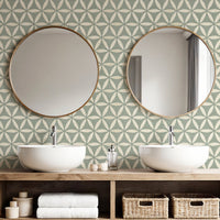 Light teal sacred geometric wallpaper in bathroom with double basins and round gold mirrors