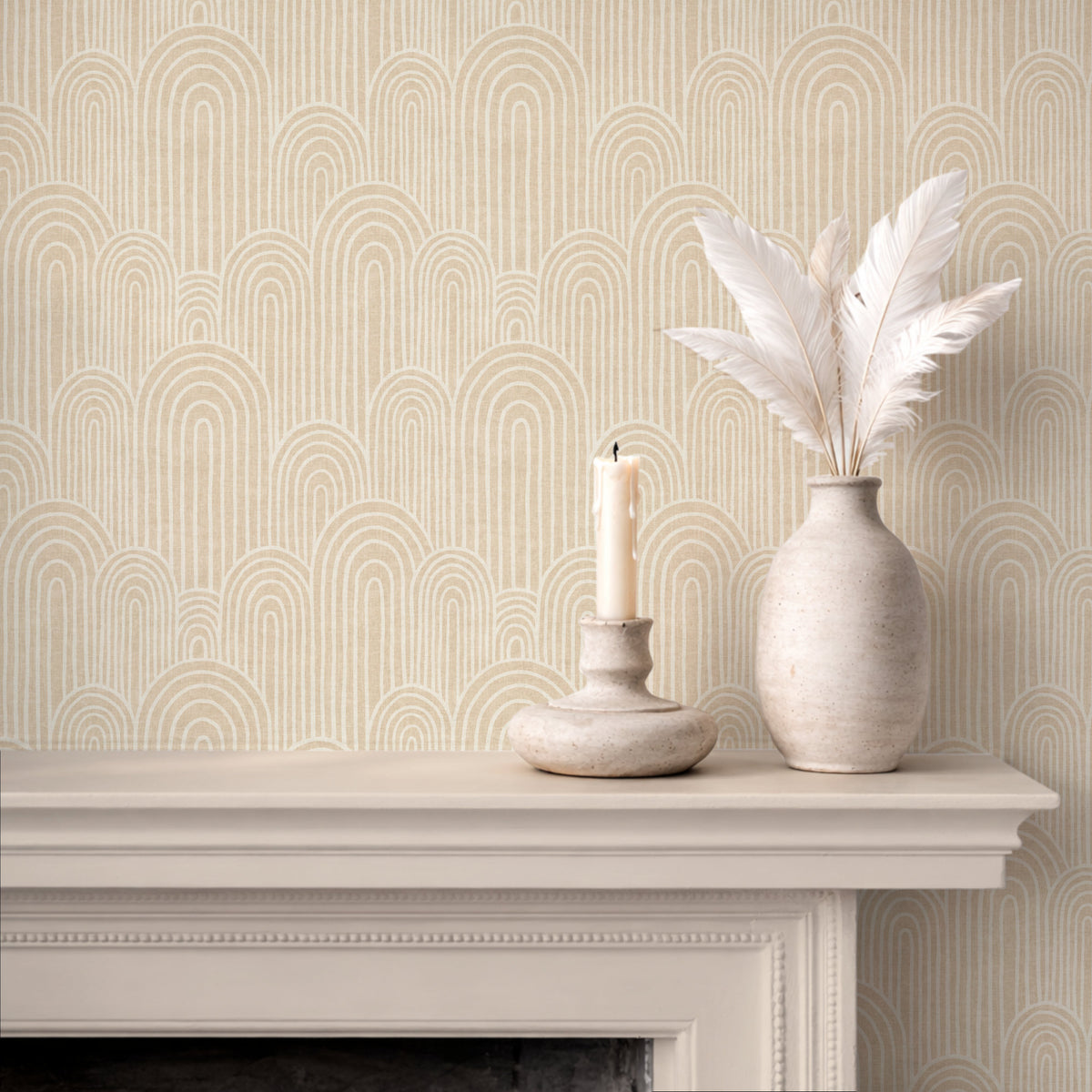 Warm beige arches wallpaper above fireplace with candle and ceramic vase
