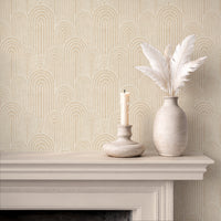 Warm beige arches wallpaper above fireplace with candle and ceramic vase