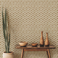 Golden brown geometric wallpaper with flower of life design in a contemporary living room with pottery decor