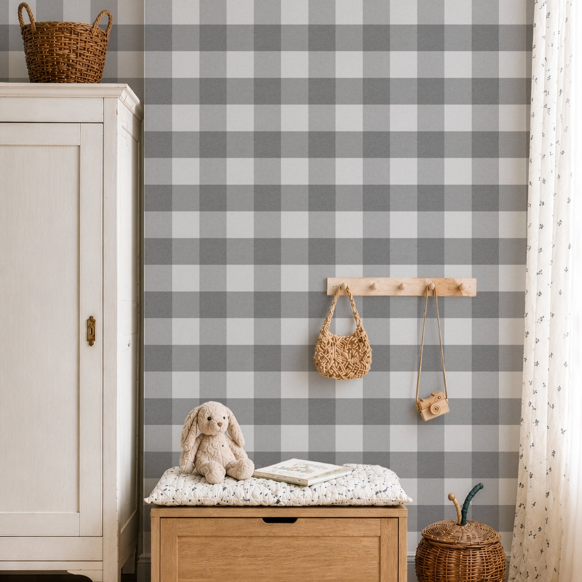 Gray and white checked gingham wallpaper in a styled nursery or playroom setting, featuring a wooden toy chest, a plush bunny, a hanging wooden peg rack with woven bags, and a white cabinet.
