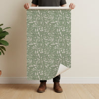 Brushstroke wallpaper roll in sage green showing abstract painterly pattern