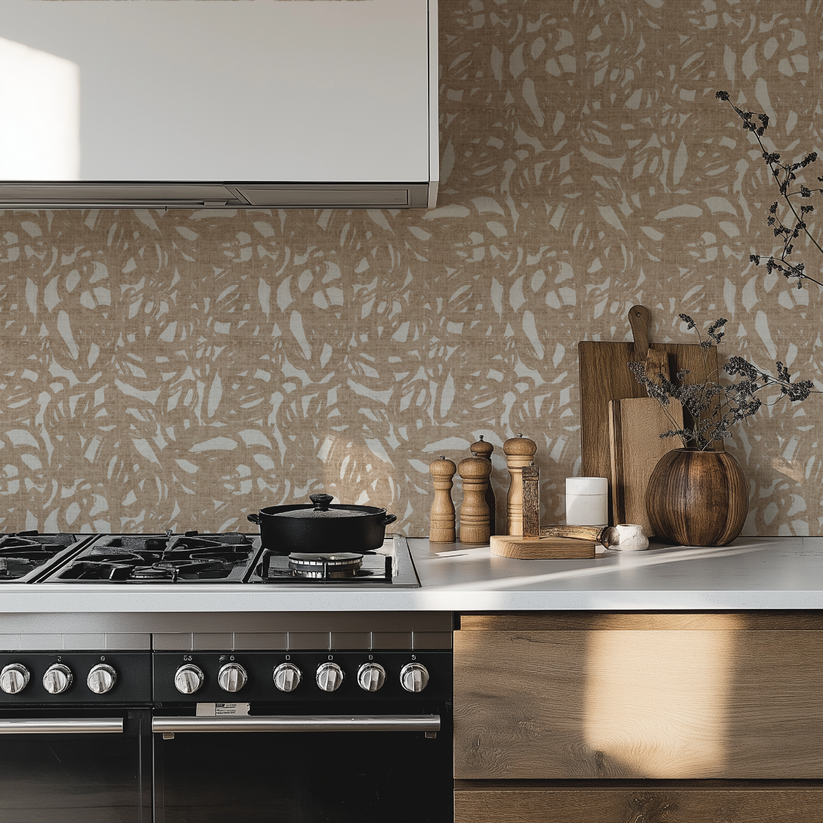 Modern kitchen with an abstract brush stroke patterned wall, stove, and decorative items.