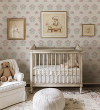 Dusty pink vintage floral wallpaper in nursery with white cot and soft neutral decor