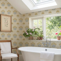 Vintage floral wallpaper in slate blue and ochre yellow in bathroom with freestanding bath