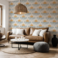 moder living room featuring boho coastal wallpaper in peel and stick. Brown leather sofe, puff and rattan light shade