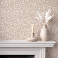 Botanical leaf silhouette wallpaper in dusty light pink on fireplace mantel with white vases
