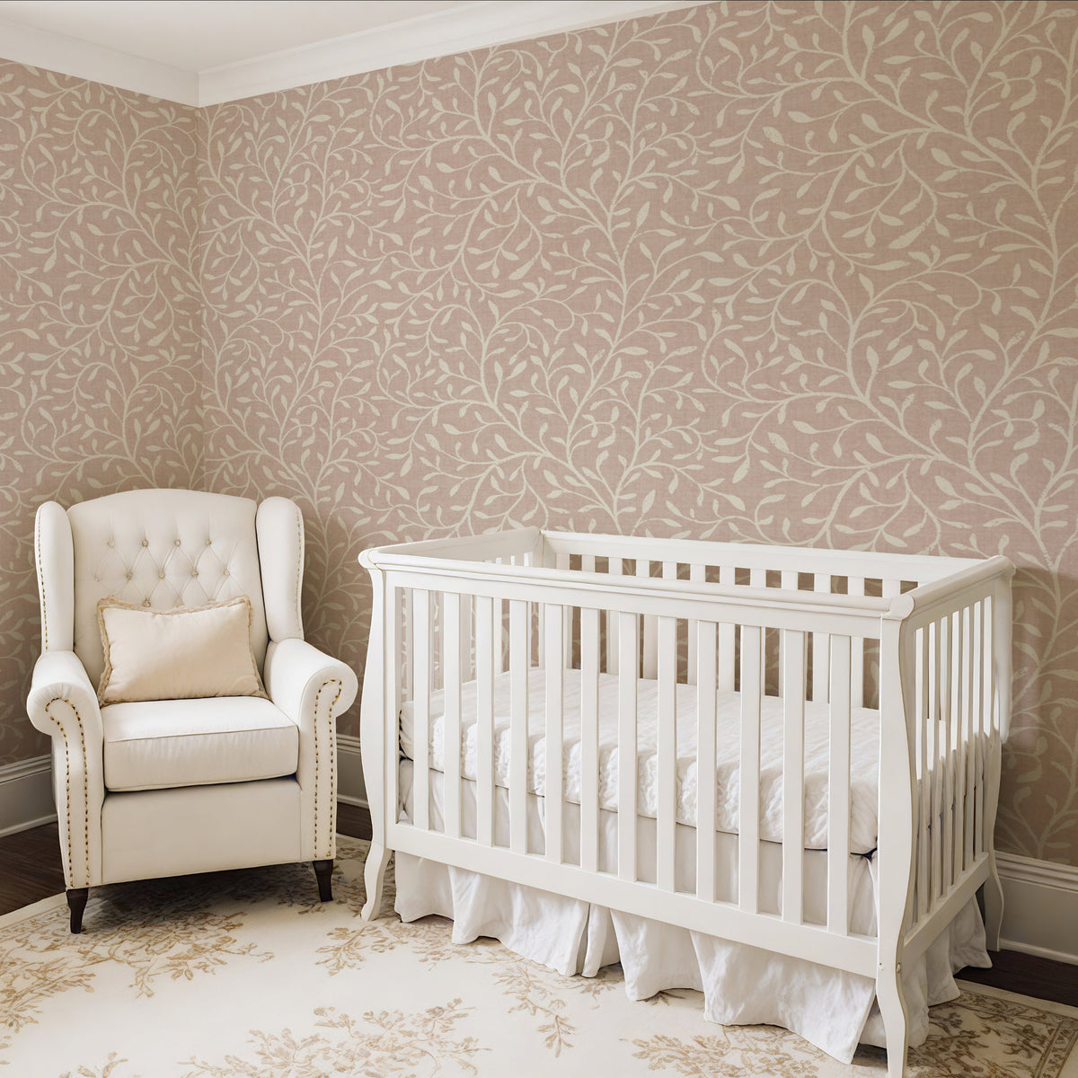 Botanical leaf wallpaper in warm beige in nursery with white cot and armchair