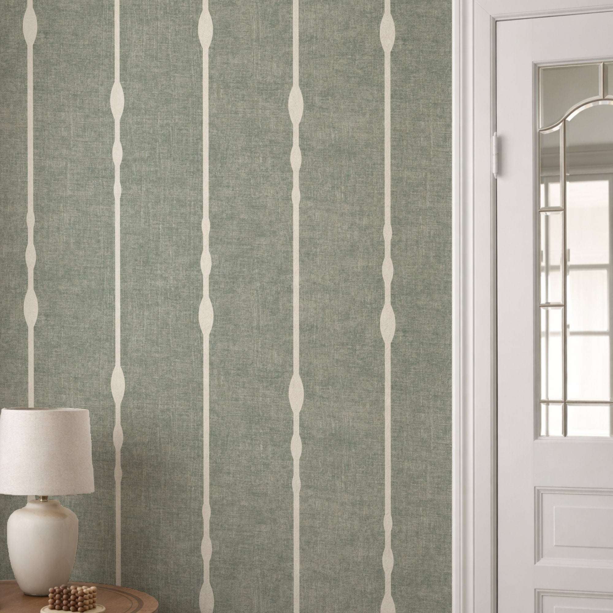 Vertical striped wallpaper with beaded stripe motif on muted green ground and pale vertical columns
