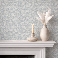 Japandi botanical wallpaper in soft blue on fireplace wall with neutral decor