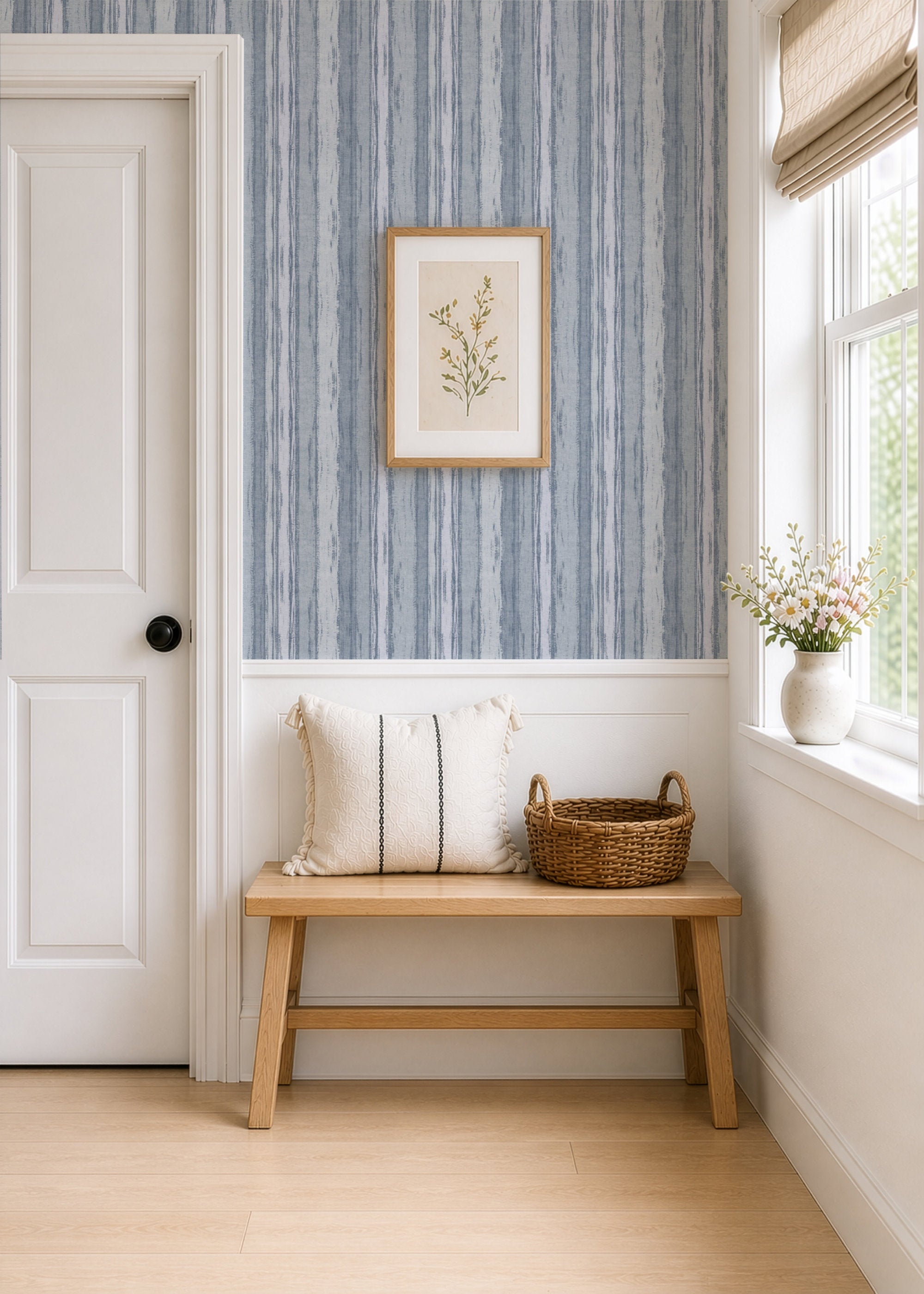 A cozy interior featuring abstract stripe wallpaper in blue tones, a wooden bench, and natural decor accents.