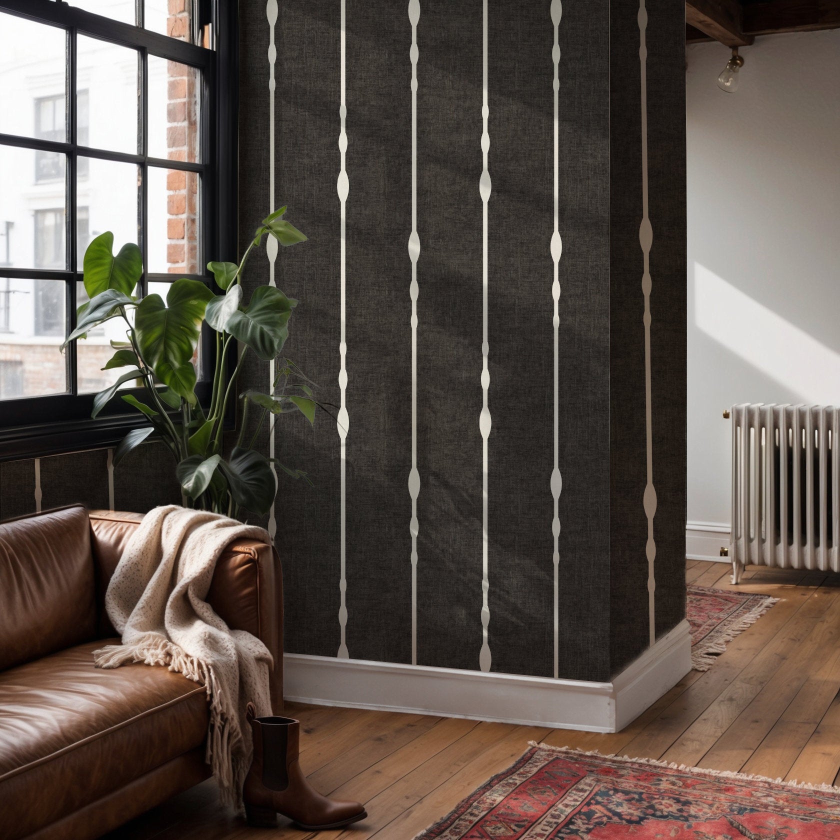 Black and white vertical striped wallpaper as feature wall in living room with leather sofa and plants