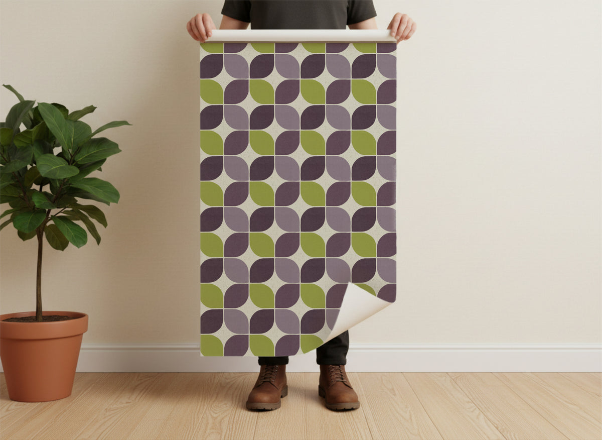 A man holding a physical roll of the Mid-century modern geometric square wallpaper. This shot demonstrates the scale of the pattern and the tangible quality of the paper against a person's hands.