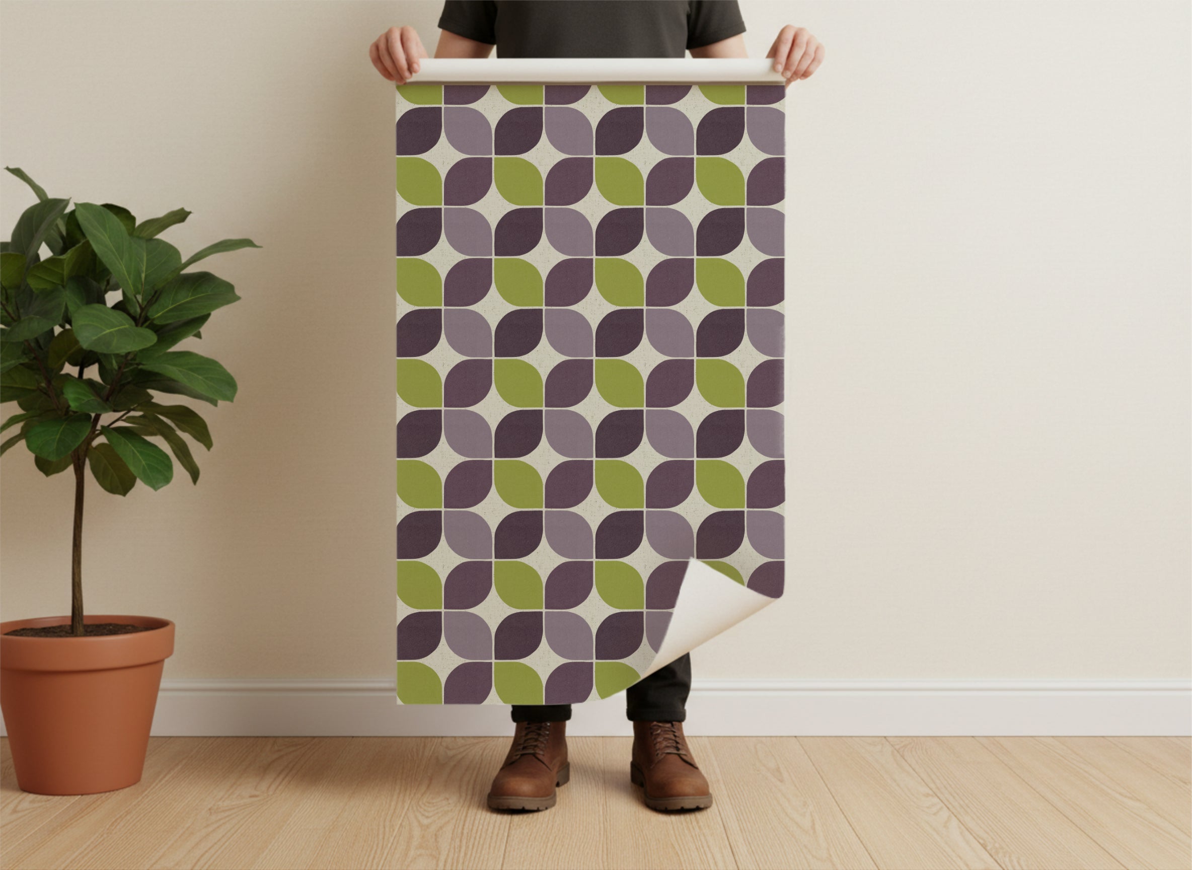 A man holding a physical roll of the Mid-century modern geometric square wallpaper. This shot demonstrates the scale of the pattern and the tangible quality of the paper against a person's hands.