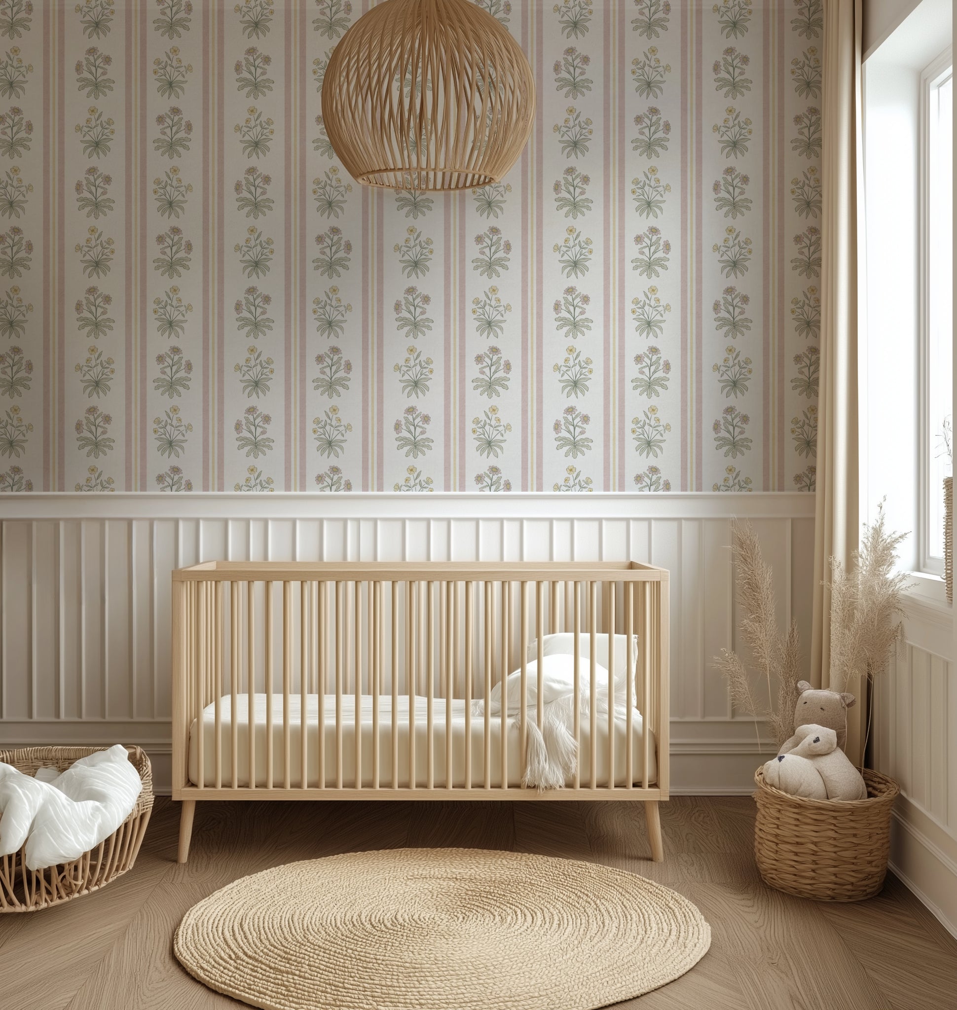 Pink and yellow floral striped wallpaper in a cosy nursery with a cot and natural decor