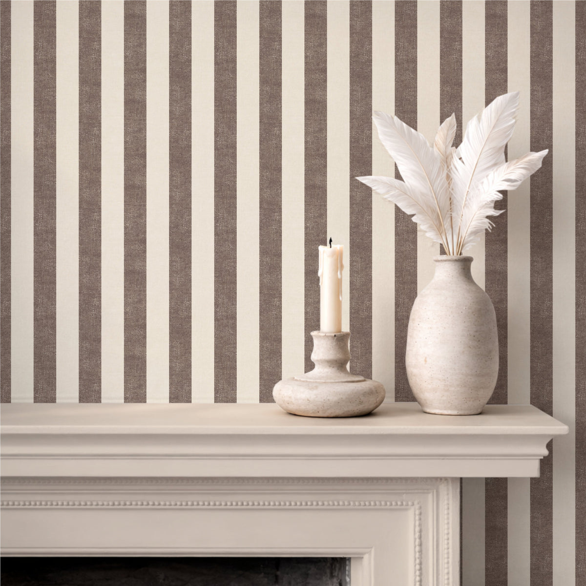 Textural wide stripe wallpaper in mocha brown, styled with a fireplace mantel and white ceramic vases, farmhouse interior
